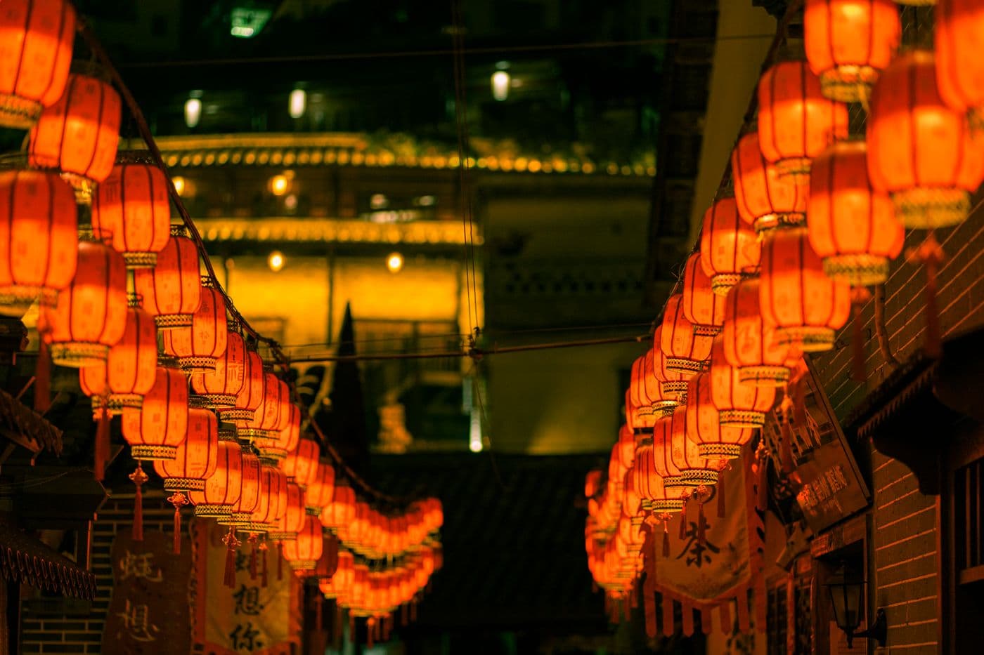 Red Chinese lanterns over a night-market street